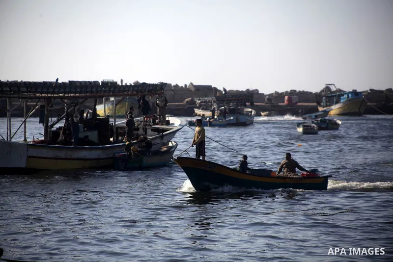 Palestinian fishermen work on their boats at the port in Gaza City, Tuesday, May 21, 2013. Israel on Tuesday expanded the distance it permits Gaza fishermen to head out to sea from 3 miles to 6 miles, restoring a limit i...