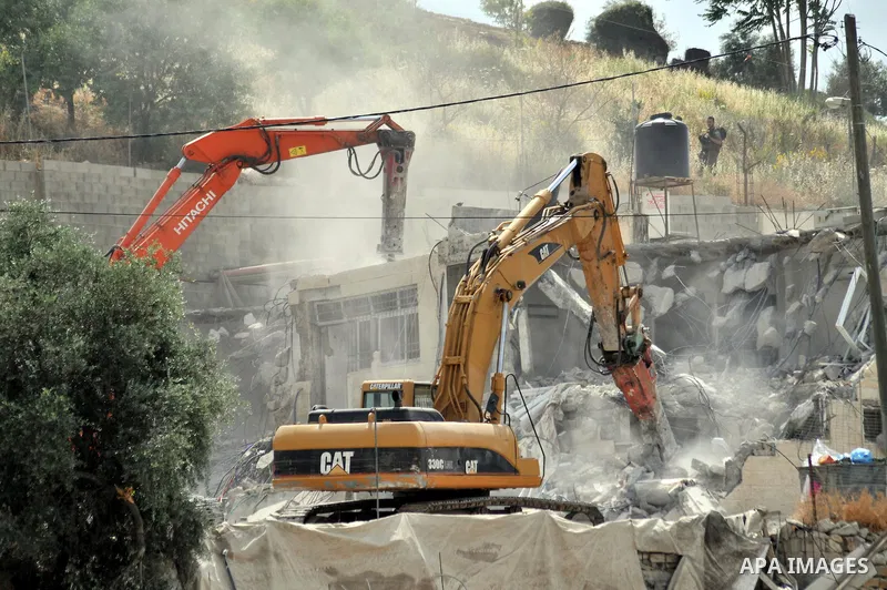 Israeli bulldozers destroy a home in the neighborhood of al-Tur in Israeli-occupied east Jerusalem on May 21, 2013, in implementation of a court order which ruled that the house was built without a municipality permit. P...