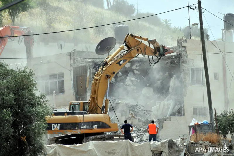 Israeli bulldozers destroy a home in the neighborhood of al-Tur in Israeli-occupied east Jerusalem on May 21, 2013, in implementation of a court order which ruled that the house was built without a municipality permit. P...