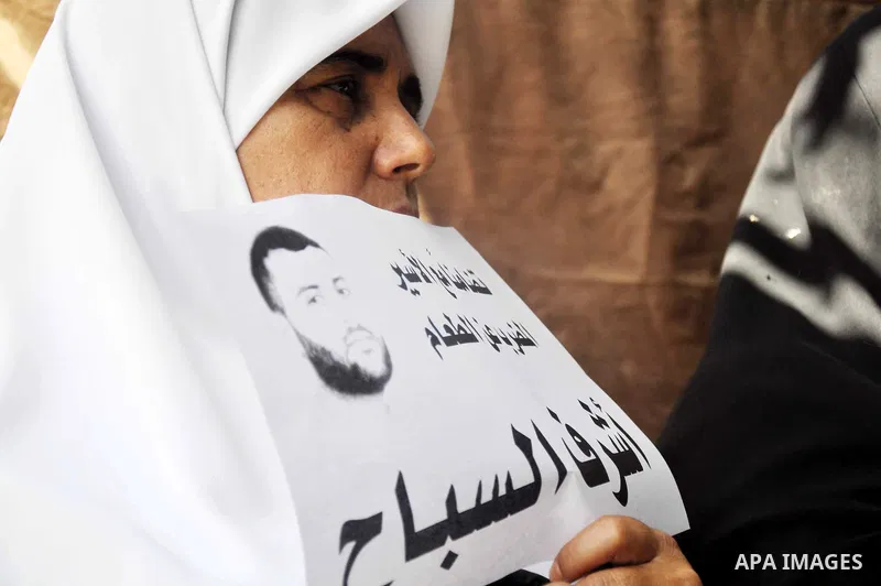Palestinians hold pictures of prisoners held in Israeli jails during a protest in Gaza City, on May. 23, 2013 in solidarity with Palestinian prisoners on hunger strike in Israeli jails. Photo by Mohammed Talatene