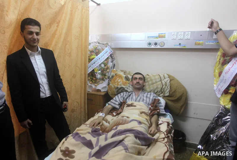 A Palestinian patient lays on a bed at al-Shifa hospital after he was suffering from the carbon dioxide gas in Gaza city on May 23, 2013. The health ministry in Gaza warned Thursday that Israel has filled anesthesia gas...