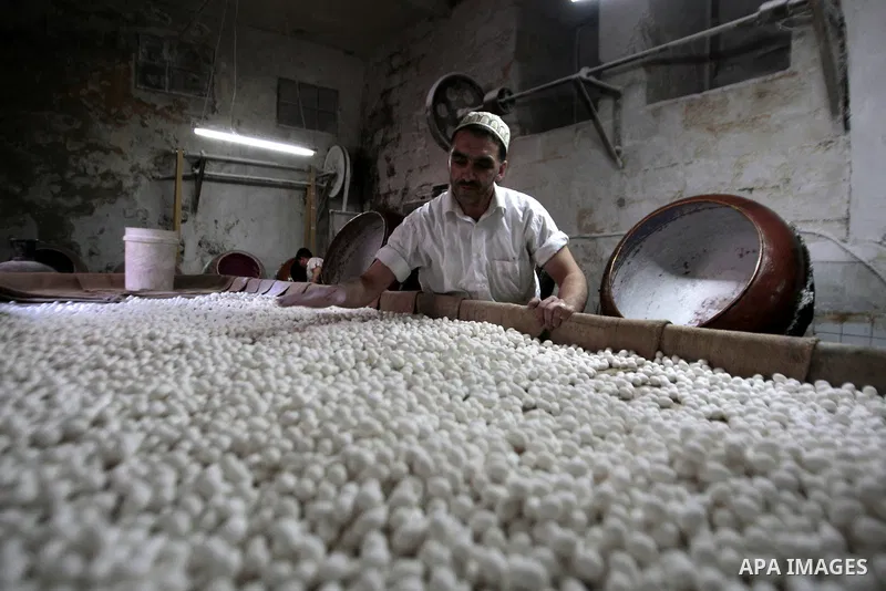 A Palestinian man prepares traditional candy containing groundnut and sugar at his workshop in the West Bank city of Nablus, on May 23, 2013. Photo by Nedal Eshtayah