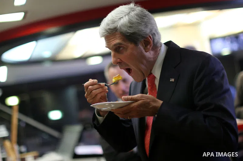 U.S. Secretary of State John Kerry eats Sweets inside a shop after his meeting with Palestinian President Mahmoud Abbas in the west bank city of Ramallah on May 23, 2013. Kerry held talks in Jerusalem and Ramallah on 23...