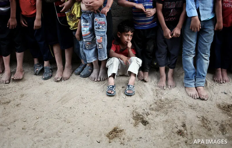 Palestinian refugee children play outside their houses in a poverty-stricken quarter of the town of Beit Lahiya, northern Gaza Strip, 23 May 2013. Photo by Ali Jadallah