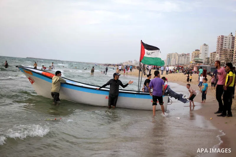 Palestinians enjoy riding a boat on the sea at Gaza beach during Friday holiday in Gaza city, May 24, 2013. Gazans escape to the beach and out from their homes during heat wave and power outages. Photo by Ashraf Amra