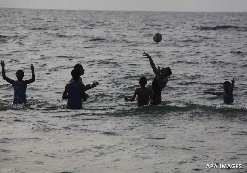 Palestinians enjoy swimming in the sea at Gaza beach during Friday holiday in Gaza city, May 24, 2013. Gazans escape to the beach and out from their homes during heat wave and power outages. Photo by Ashraf Amra