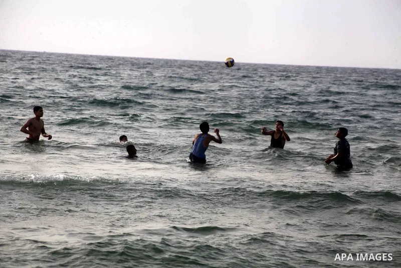 Palestinians enjoy swimming in the sea at Gaza beach during Friday holiday in Gaza city, May 24, 2013. Gazans escape to the beach and out from their homes during heat wave and power outages. Photo by Ashraf Amra