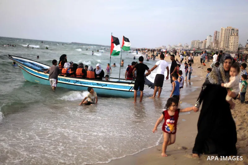 Palestinians enjoy swimming in the sea at Gaza beach during Friday holiday in Gaza city, May 24, 2013. Gazans escape to the beach and out from their homes during heat wave and power outages. Photo by Ashraf Amra