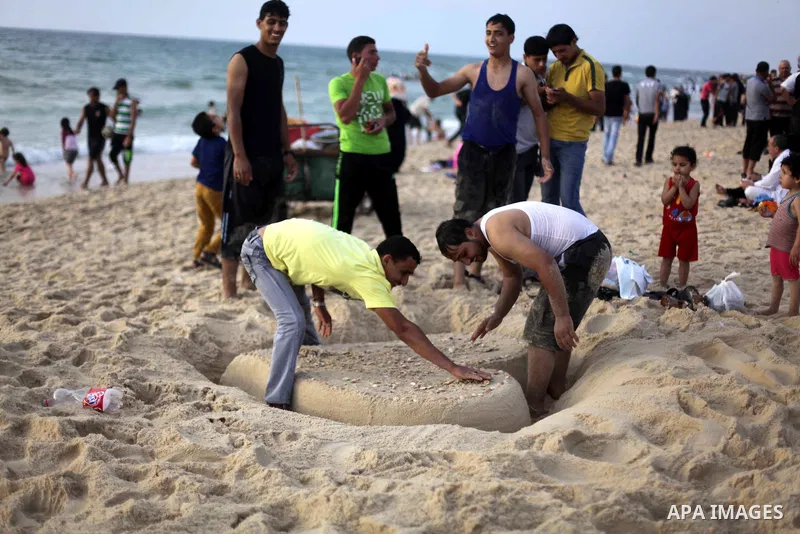 Palestinians enjoy swimming in the sea at Gaza beach during Friday holiday in Gaza city, May 24, 2013. Gazans escape to the beach and out from their homes during heat wave and power outages. Photo by Ashraf Amra