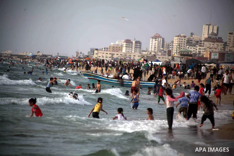 Palestinians enjoy swimming in the sea at Gaza beach during Friday holiday in Gaza city, May 24, 2013. Gazans escape to the beach and out from their homes during heat wave and power outages. Photo by Ashraf Amra
