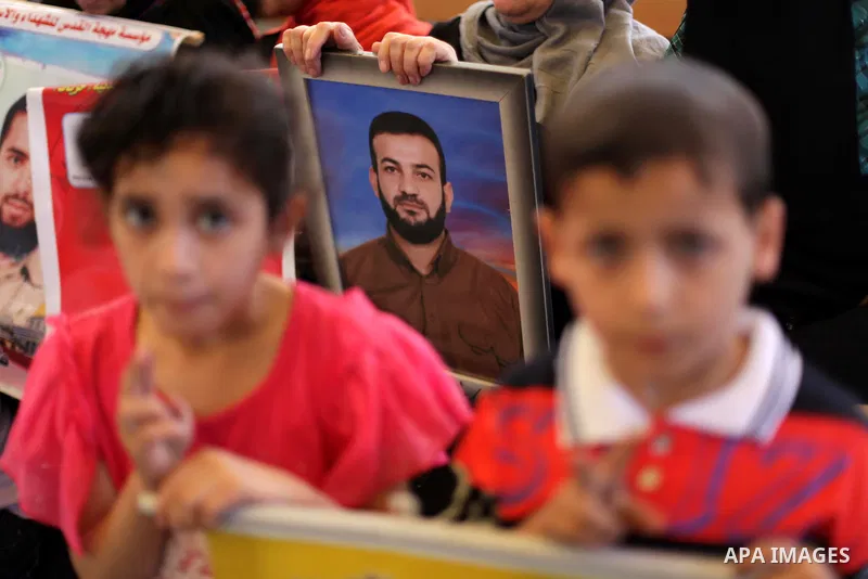 Palestinian children hold pictures of prisoners held in Israeli jails during a protest at inside Red Cross office in Gaza City, on May. 27, 2013 in solidarity with Palestinian prisoners held by Israel to demand their rel...