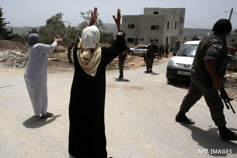 Palestinian women shout at Israeli border guards during clashes following a protest against the expropriation of Palestinian land by Israel on March 31, 2013 in the village of Kfar Qaddum, near the occupied West Bank cit...