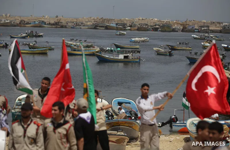 Palestinians hold Turkish flags during a rally marking the third anniversary of attack on the Turkish flotilla Mavi Marmara at Gaza seaport on May 31, 2013. Turkey broke off diplomatic relations with Israel in 2010, afte...