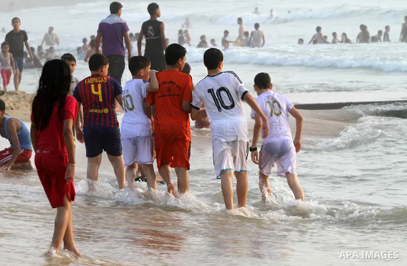 Palestinian children play on the beach during a sunny day on June 01, 2013 in Gaza City. Photo by Yasser Qudeh