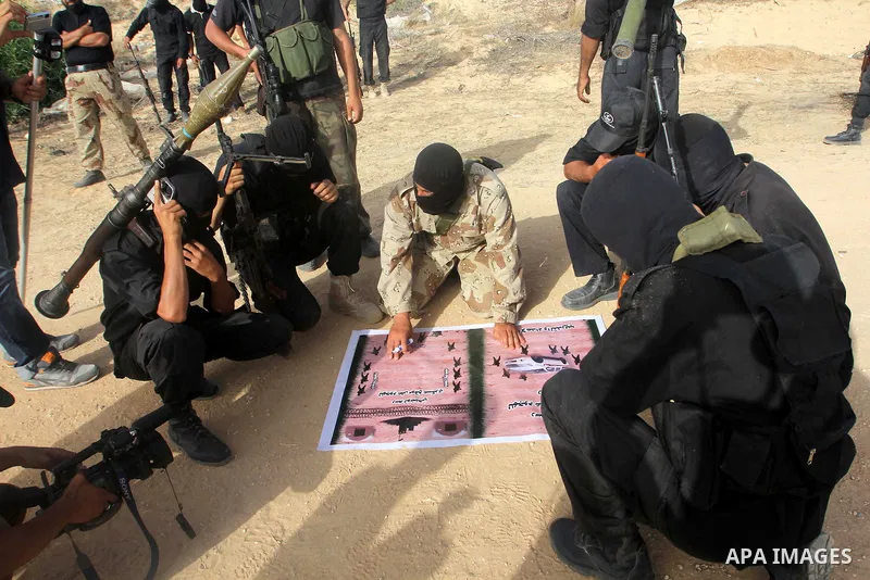 Members of the al-Nasser Salah al-Din Brigades, the military wing of the Popular Resistance Committees, participate in a military graduation ceremony in Rafah in the southern Gaza Strip June 2, 2013. Photo by Hatem Omar