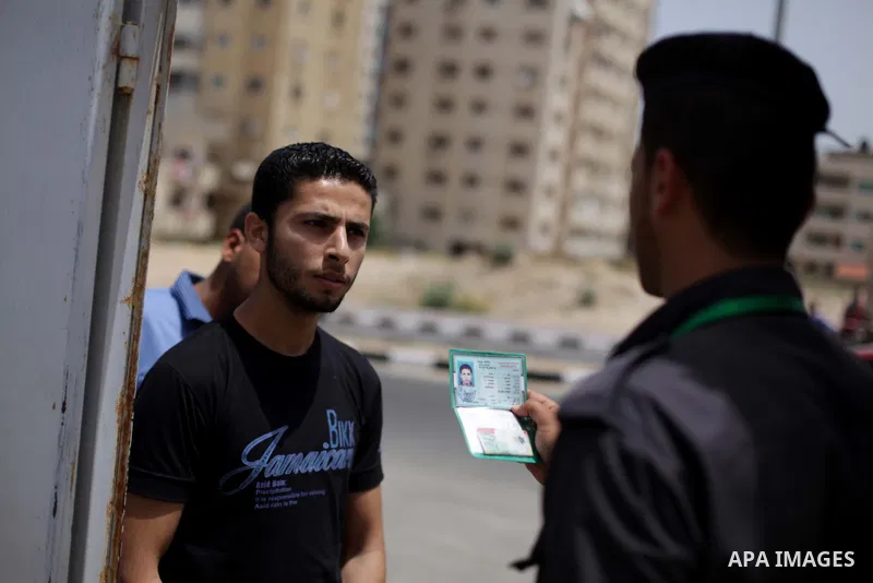 A member of Palestinian security forces calls the names of applicants at a recruitment centre in Gaza City June 3, 2013. One hundred recruits from 14,000 applicants aged between 18 to 25 will be chosen to join the Palest...