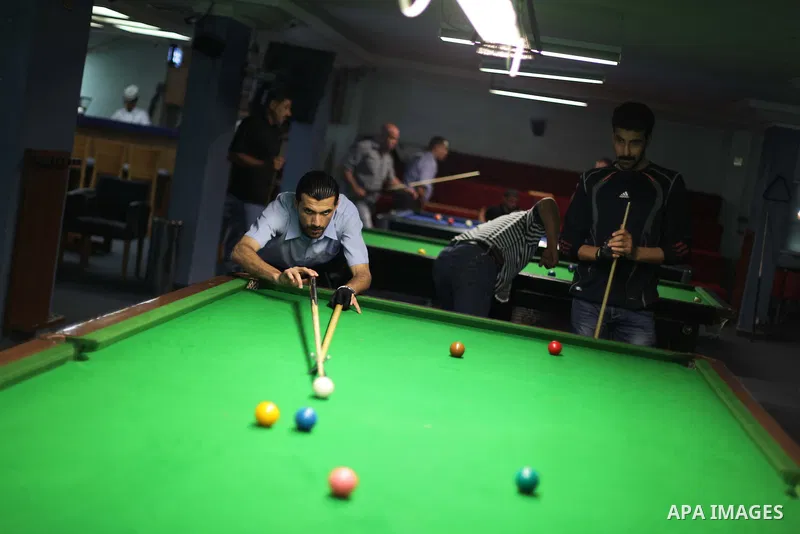 Palestinians play billiard at a games club in Gaza city June 05, 2013. Photo by Ashraf Amra