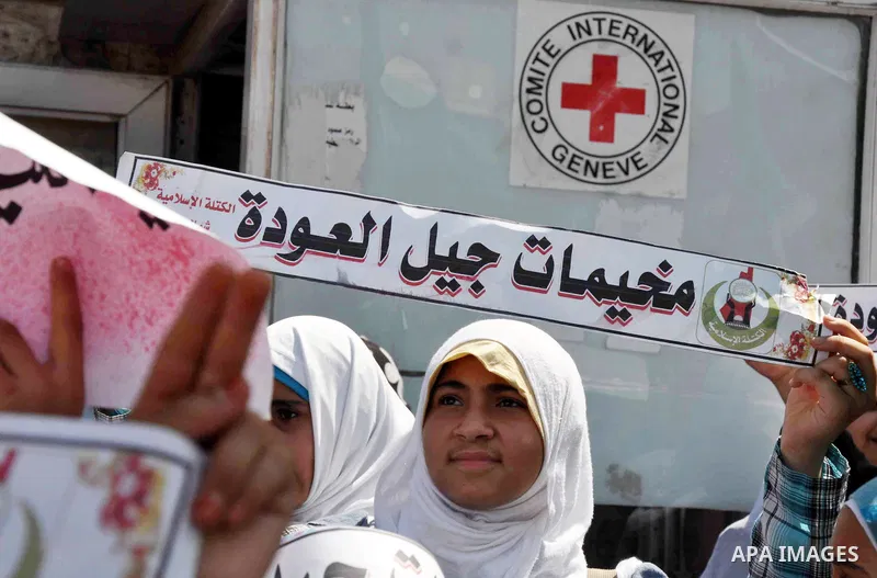 Palestinian children hold banners during a protest outside Red Cross office in Gaza City, on June 10, 2013 in solidarity with Palestinian prisoners held by Israel to demand their release from detention without trial. Pho...