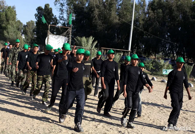 Young Palestinians take part in a military-style exercise run by Hamas during summer vacation in Gaza City June 10, 2013. Photo by Ashraf Amra