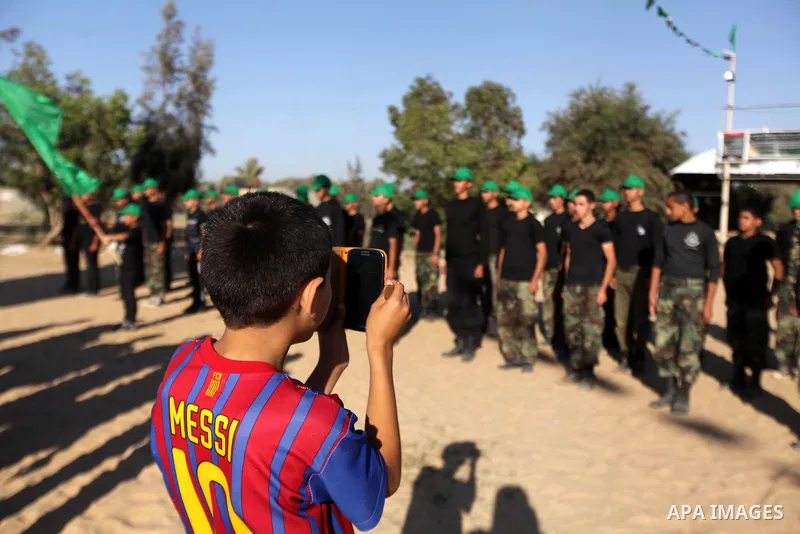 Young Palestinians take part in a military-style exercise run by Hamas during summer vacation in Gaza City June 10, 2013. Photo by Ashraf Amra