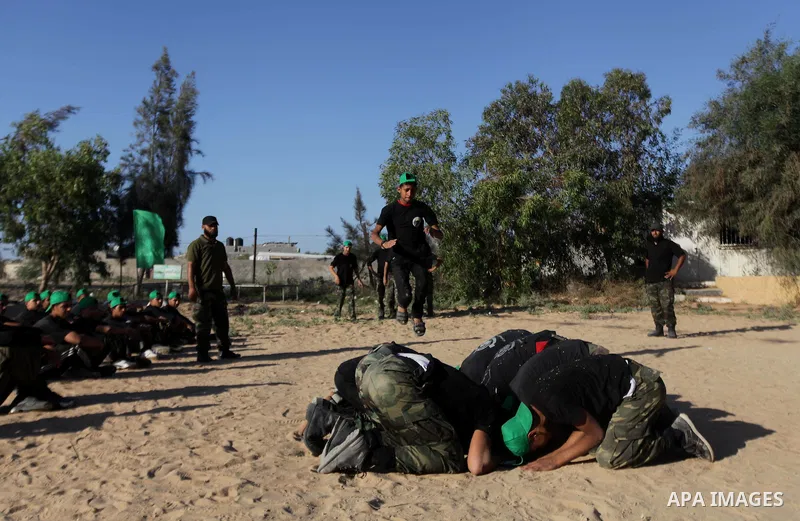 Young Palestinians take part in a military-style exercise run by Hamas during summer vacation in Gaza City June 10, 2013. Photo by Ashraf Amra