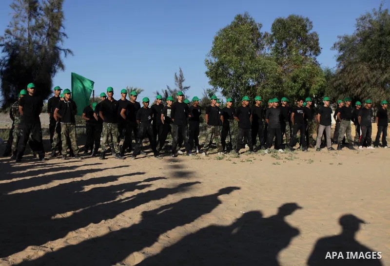 Young Palestinians take part in a military-style exercise run by Hamas during summer vacation in Gaza City June 10, 2013. Photo by Ashraf Amra