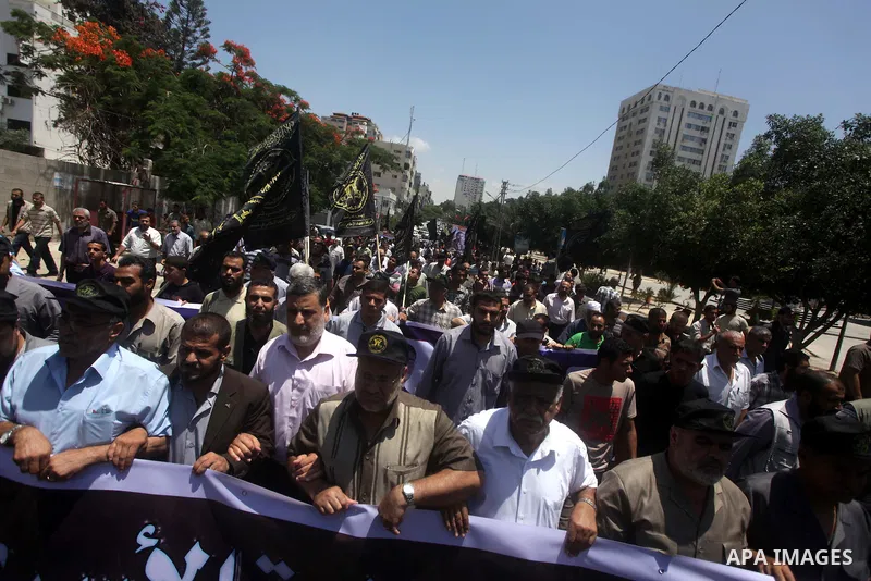 Palestinian Jihad Islamic supporters hold banners during a protest outside Red Cross office in Gaza City, on June 13, 2013 in solidarity with Palestinian prisoners held by Israel to demand their release from detention wi...
