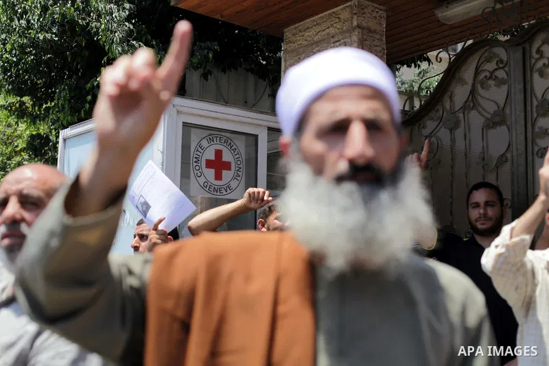 Palestinian Jihad Islamic supporters hold banners during a protest outside Red Cross office in Gaza City, on June 13, 2013 in solidarity with Palestinian prisoners held by Israel to demand their release from detention wi...