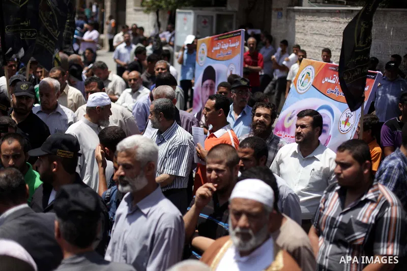 Palestinian Jihad Islamic supporters hold banners during a protest outside Red Cross office in Gaza City, on June 13, 2013 in solidarity with Palestinian prisoners held by Israel to demand their release from detention wi...