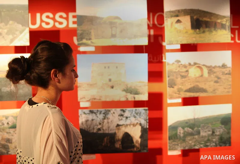 Palestinians participate in the photo gallery of our roots between past and present, organized by the foundation of Canaan in Yabous cultural center in Jerusalem, on June 15, 2013. Photo by Saeed Qaq
