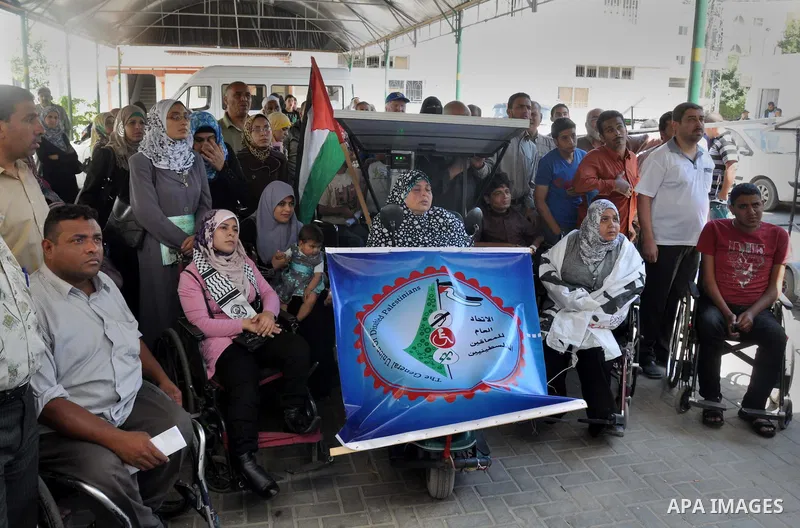 Palestinians from the General Union of Disabled take part a protest in front of the headquarters of the Ministry of Labour to demand their employment, in Gaza city on June 16, 2013. Photo by Mohammed Talatene
