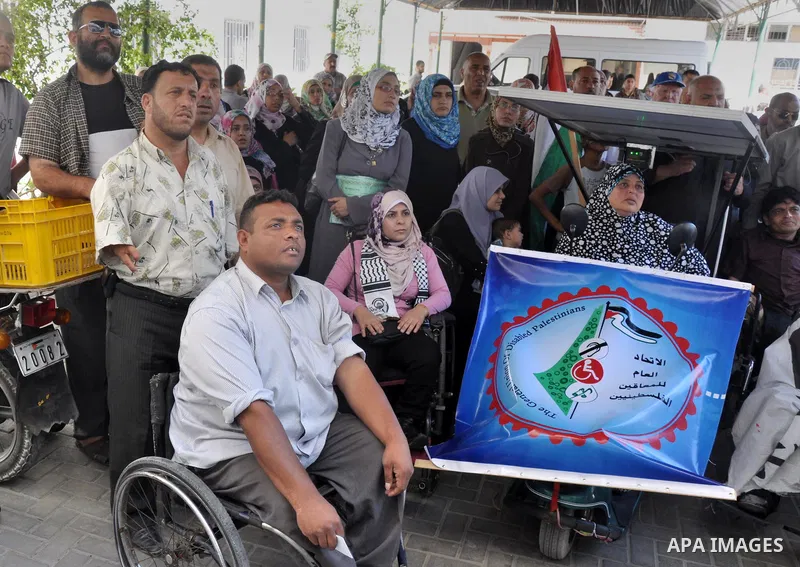 Palestinians from the General Union of Disabled take part a protest in front of the headquarters of the Ministry of Labour to demand their employment, in Gaza city on June 16, 2013. Photo by Mohammed Talatene