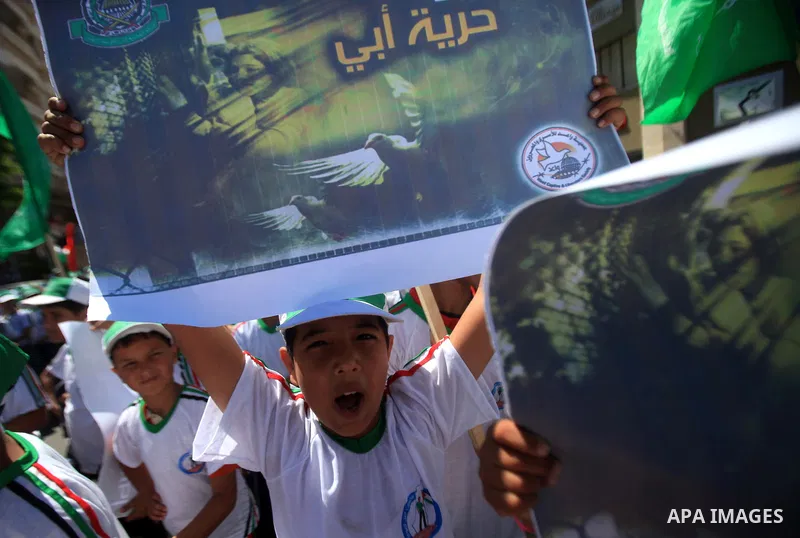 Palestinian children hold banners during a march solidarity with Palestinian prisoners held by Israel to demand their release from detention without trial in Gaza City, on June 17, 2013. Photo by Ashraf Amra