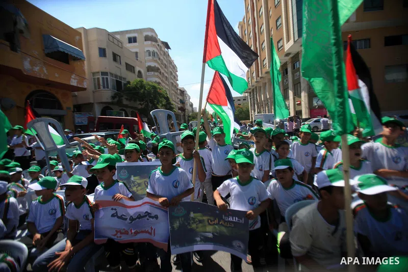 Palestinian children hold banners during a march solidarity with Palestinian prisoners held by Israel to demand their release from detention without trial in Gaza City, on June 17, 2013. Photo by Ashraf Amra