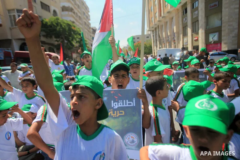 Palestinian children hold banners during a march solidarity with Palestinian prisoners held by Israel to demand their release from detention without trial in Gaza City, on June 17, 2013. Photo by Ashraf Amra