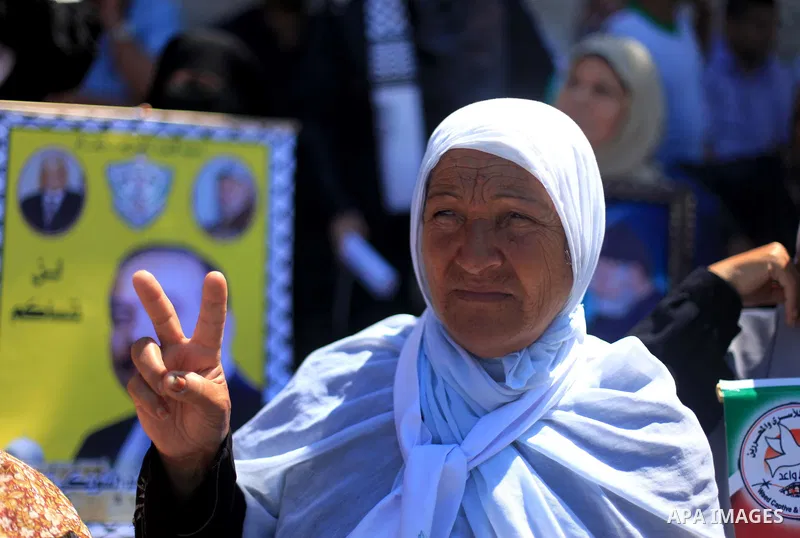 Palestinian women hold pictures of prisoners held in Israeli jails during a protest outside Red Cross office in Gaza City, on June 17, 2013 in solidarity with Palestinian prisoners held by Israel to demand their release...