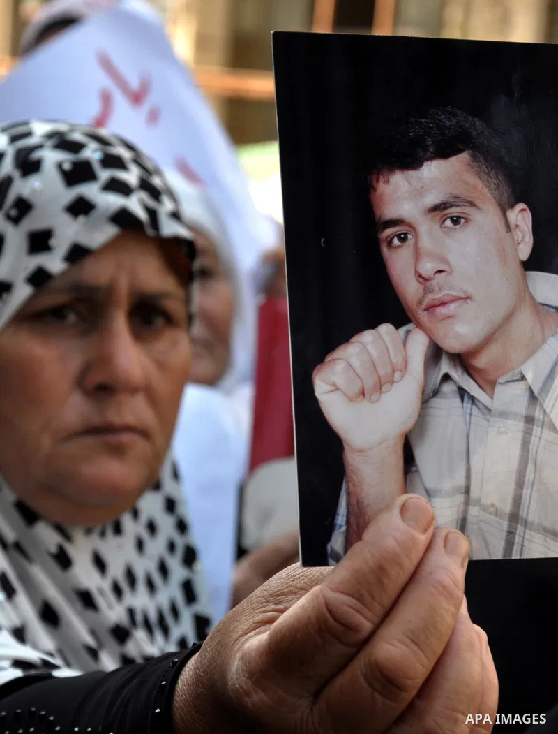 Palestinian families of martyrs take part a protest in front of the headquarters of the Palestine Liberation organization to demand their financial dues in Gaza City, on June 18, 2013. Photo by Mohammed Talatene