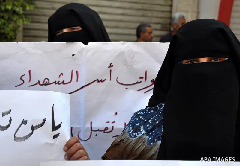Palestinian families of martyrs take part a protest in front of the headquarters of the Palestine Liberation organization to demand their financial dues in Gaza City, on June 18, 2013. Photo by Mohammed Talatene