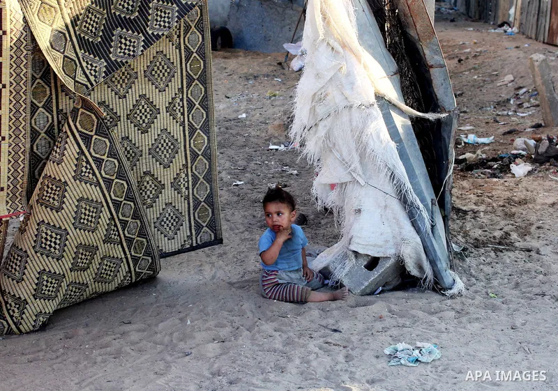 Palestinian refugees children play on the ground of their family's home in the Bait Lahiya camp, northern Gaza Strip, 18 June 2013. According to recent Palestinian media reports Beit Lahiya and its surrounding border are...