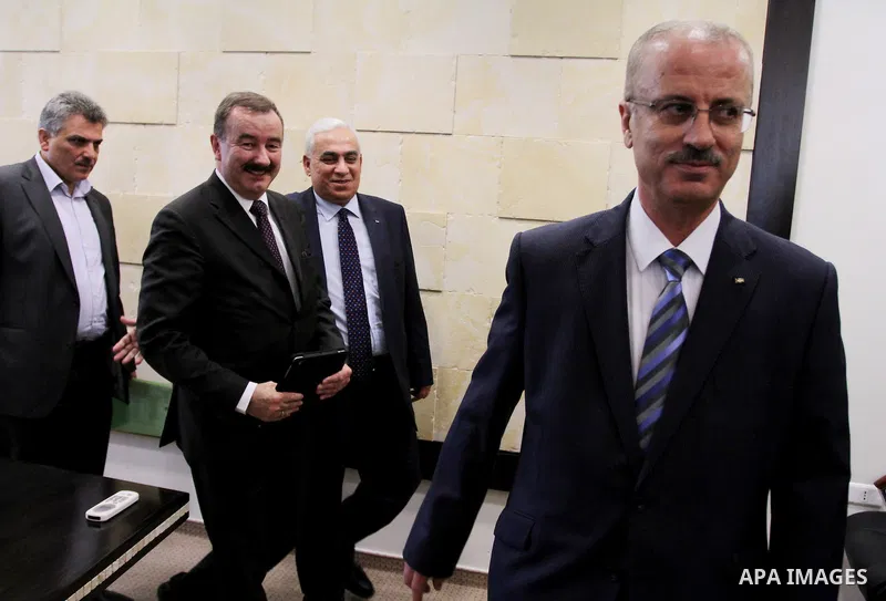 Newly appointed Palestinian Prime Minister Rami Hamdallah (R), and Director-General of the United Nations Development Programme, Frode Mauring(L), attend a signing ceremony of a cooperation agreement, in the West Bank ci...