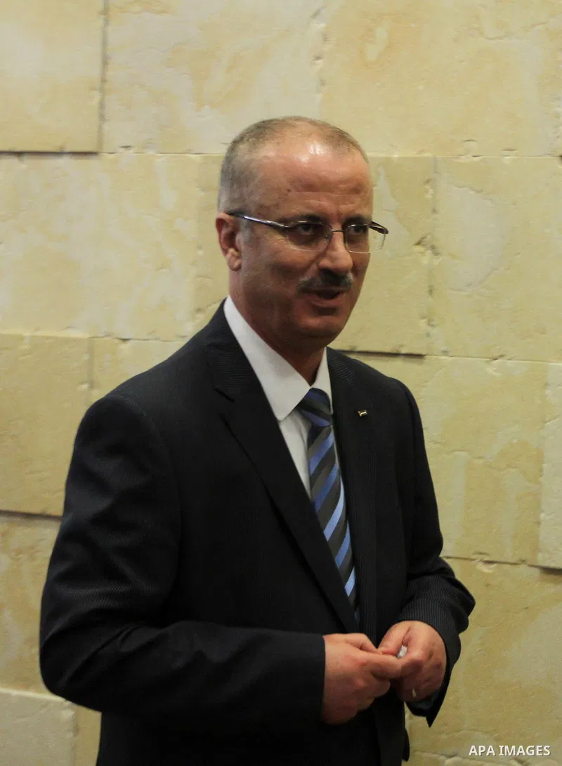 Newly appointed Palestinian Prime Minister Rami Hamdallah attends a signing ceremony of a cooperation agreement with the United Nations Development Programme (UNDP), in the West Bank city of Ramallah June 19, 2013. The a...