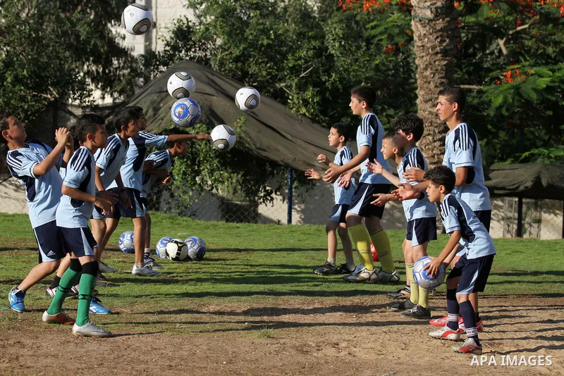 Palestinian boys play soccer in training exercises at a soccer club during their summer holiday in Gaza city on June 19, 2013. Photo by Ashraf Amra