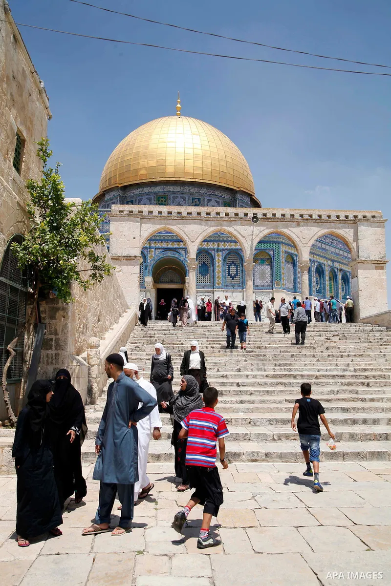Palestinian worshipers walk in front of the Dome of the Rock mosque following Friday prayers at al-Aqsa mosque compound, Islam's third holiest site, in Jerusalem's old city on June 21, 2013. Photo by Saeed Qaq
