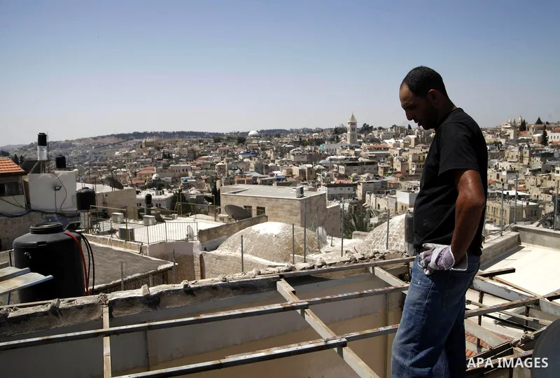 A Palestinian man from Hijazi family destroys his family home in Jerusalem's Old City on June 22, 2013. Monther Hijazi, 65, decided to demolish his own home to carry out an Israeli court order, following pay 40,000 sheke...