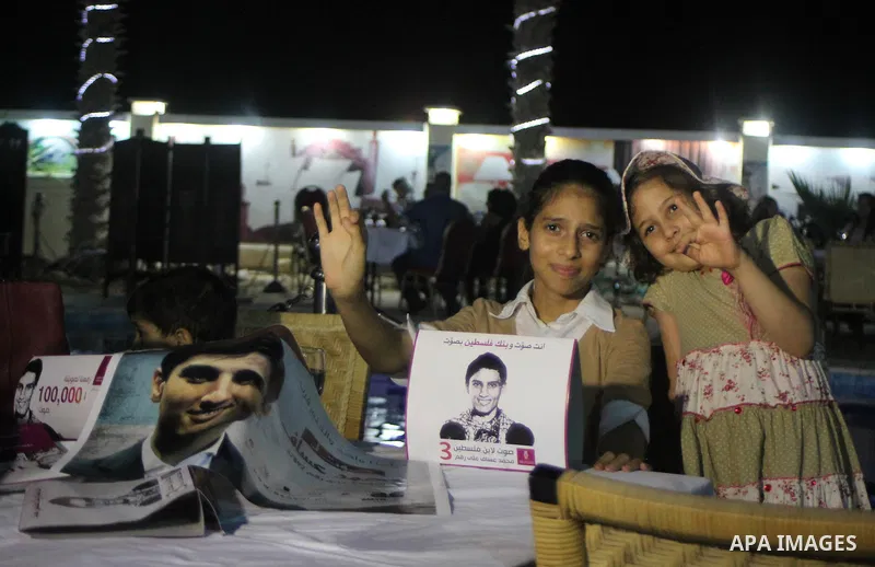 Palestinians watch the televised performance of Mohammad Assaf, 23, a Palestinian finalist on the Arab Idol talent show, in Gaza City, Friday, June 21, 2013. Assaf, Gazan's powerful voice has propelled him to the final a...
