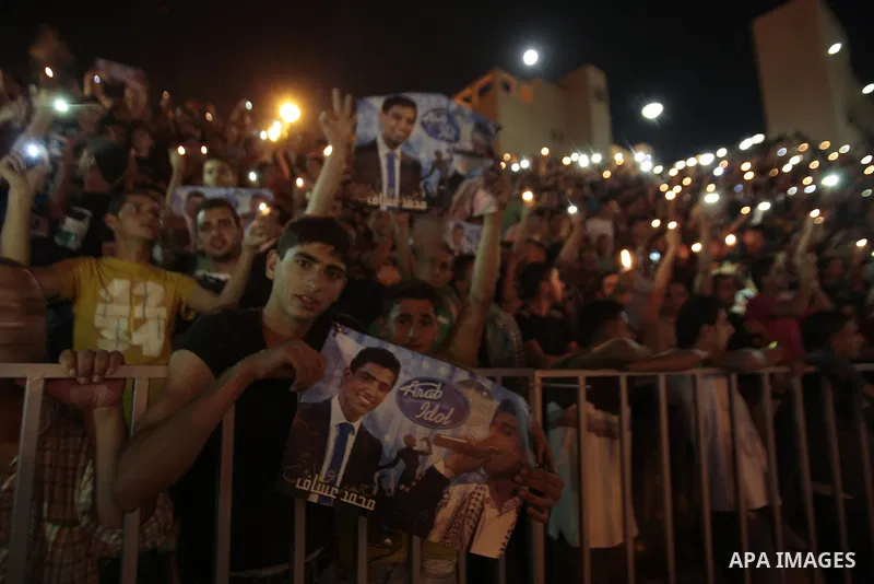 Palestinians celebrate after Palestinian singer Mohammed Assaf won a regional TV singing contest, in the West Bank city of Nablus, Saturday, June 22, 2013. Palestinians relished a rare moment of pride and national unity...