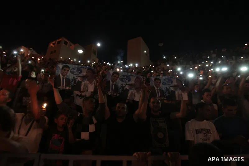 Palestinians celebrate after Palestinian singer Mohammed Assaf won a regional TV singing contest, in the West Bank city of Nablus, Saturday, June 22, 2013. Palestinians relished a rare moment of pride and national unity...