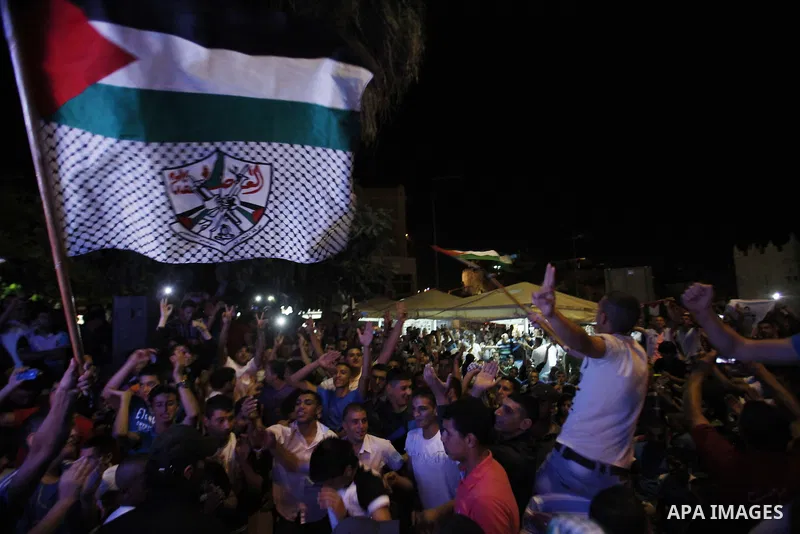 Palestinians celebrate after Palestinian singer Mohammed Assaf won a regional TV singing contest, in Jerusalem, June 22, 2013. Palestinians relished a rare moment of pride and national unity Saturday after the 23-year-ol...