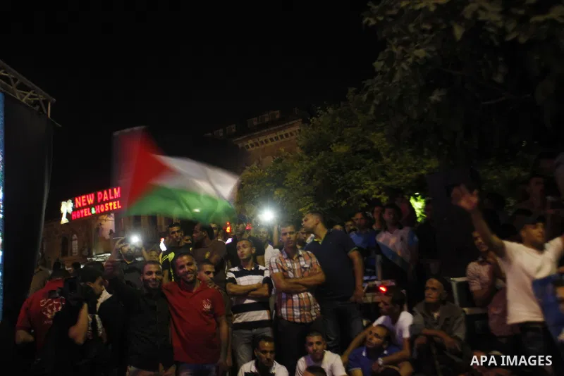 Palestinians celebrate after Palestinian singer Mohammed Assaf won a regional TV singing contest, in Jerusalem, June 22, 2013. Palestinians relished a rare moment of pride and national unity Saturday after the 23-year-ol...
