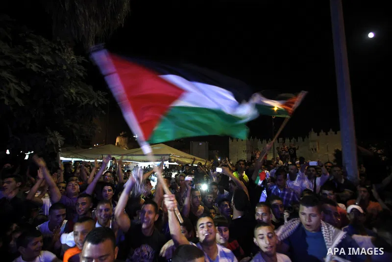 Palestinians celebrate after Palestinian singer Mohammed Assaf won a regional TV singing contest, in Jerusalem, June 22, 2013. Palestinians relished a rare moment of pride and national unity Saturday after the 23-year-ol...